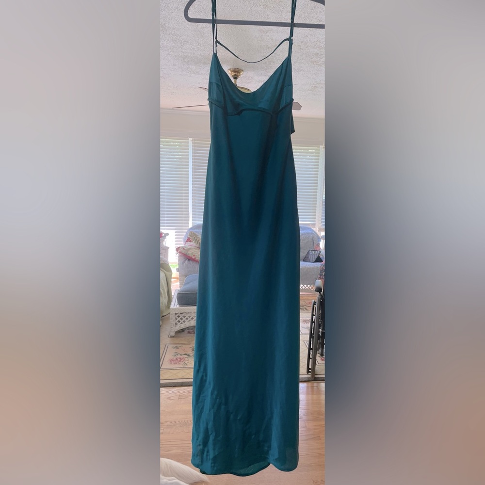 Floor length teal spaghetti strap dress with back closure.